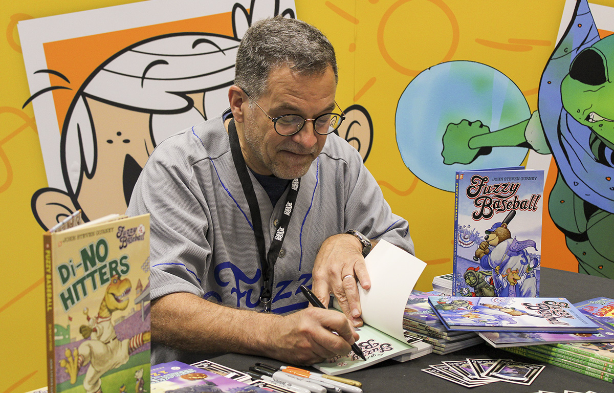 Head coach of the Fernwood Fuzzies signing copies of FUZZY BASEBALL and Baseballoween Cards